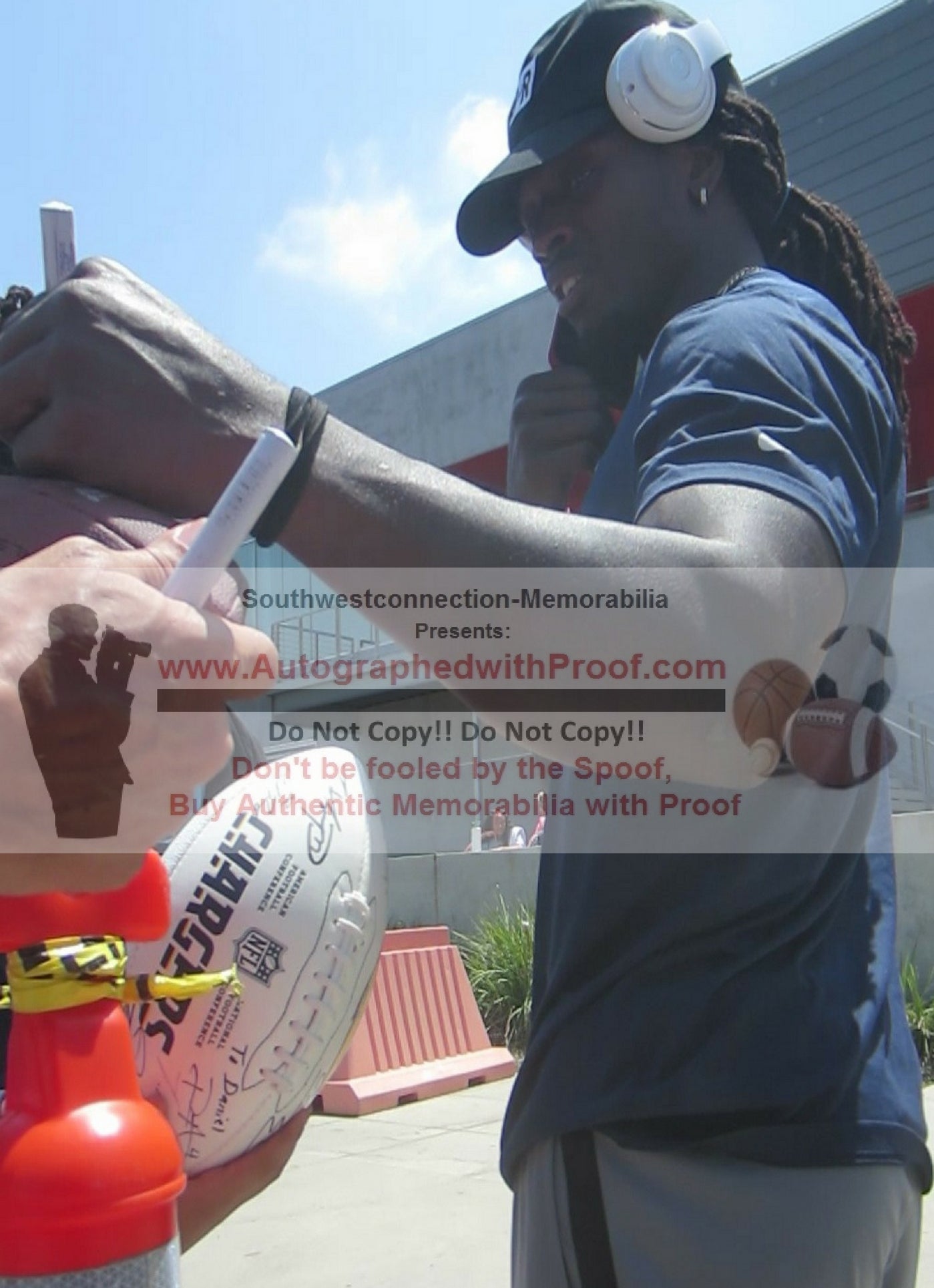Footballs- Autographed- Melvin Gordon Signing NFL Football - Denver Broncos- Los Angeles Chargers- Wisconsin Badgers- Proof Photo- JSA Authentication - 1